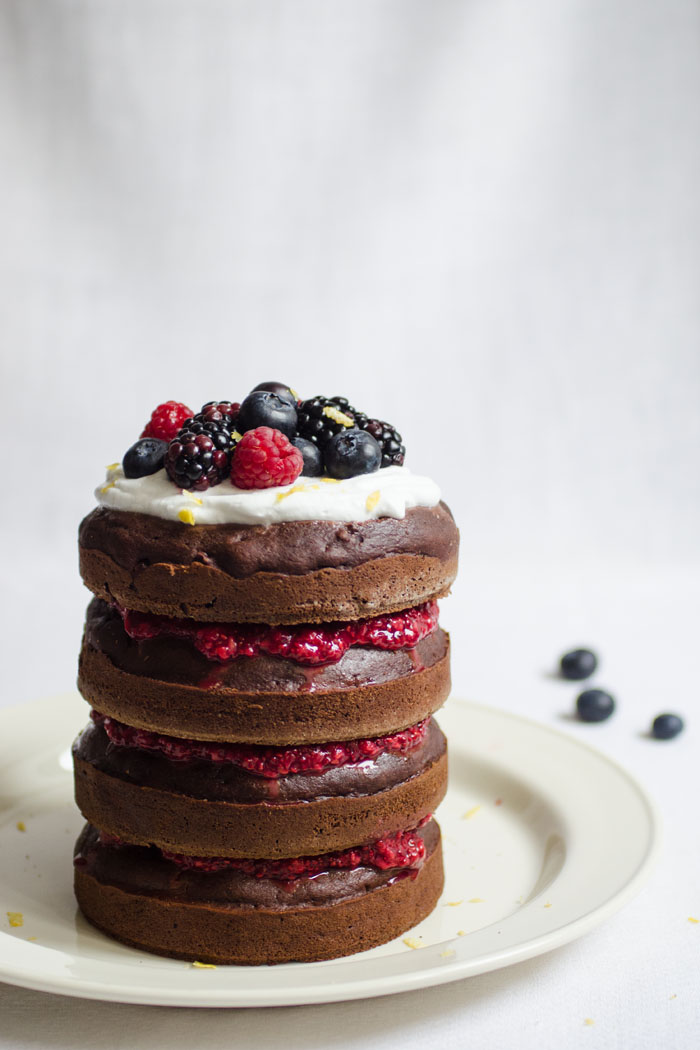 Chocolate layer cake with raspberry chia jam and coconut whipped cream 