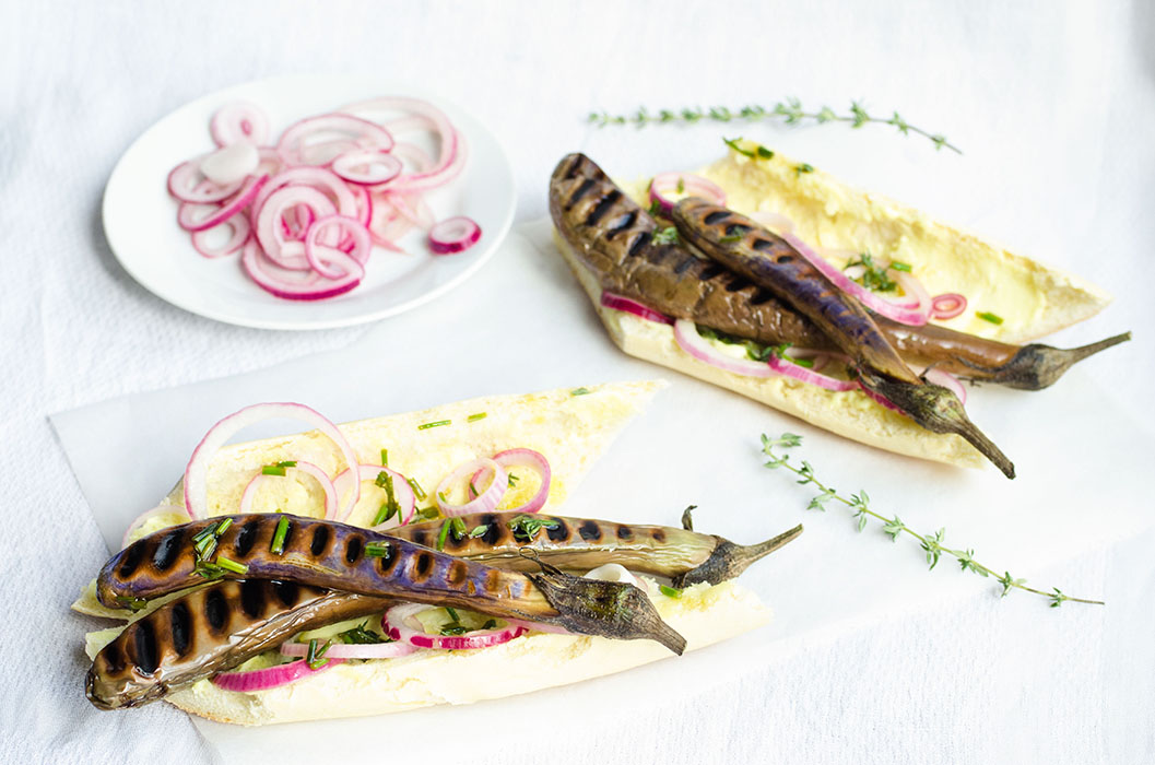 Chinese eggplant hot dogs with mustard mayo, herbed oil and quick pickled onions // vegan